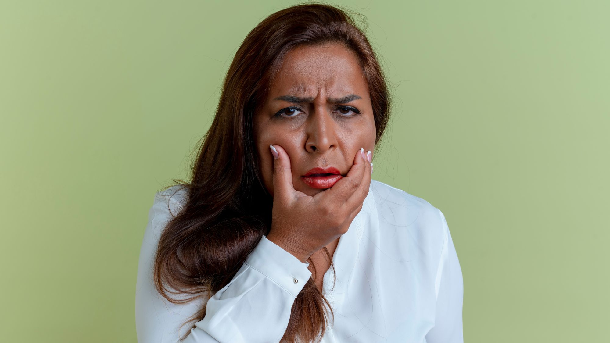 A black woman feeling pain due to a gum swelling problem