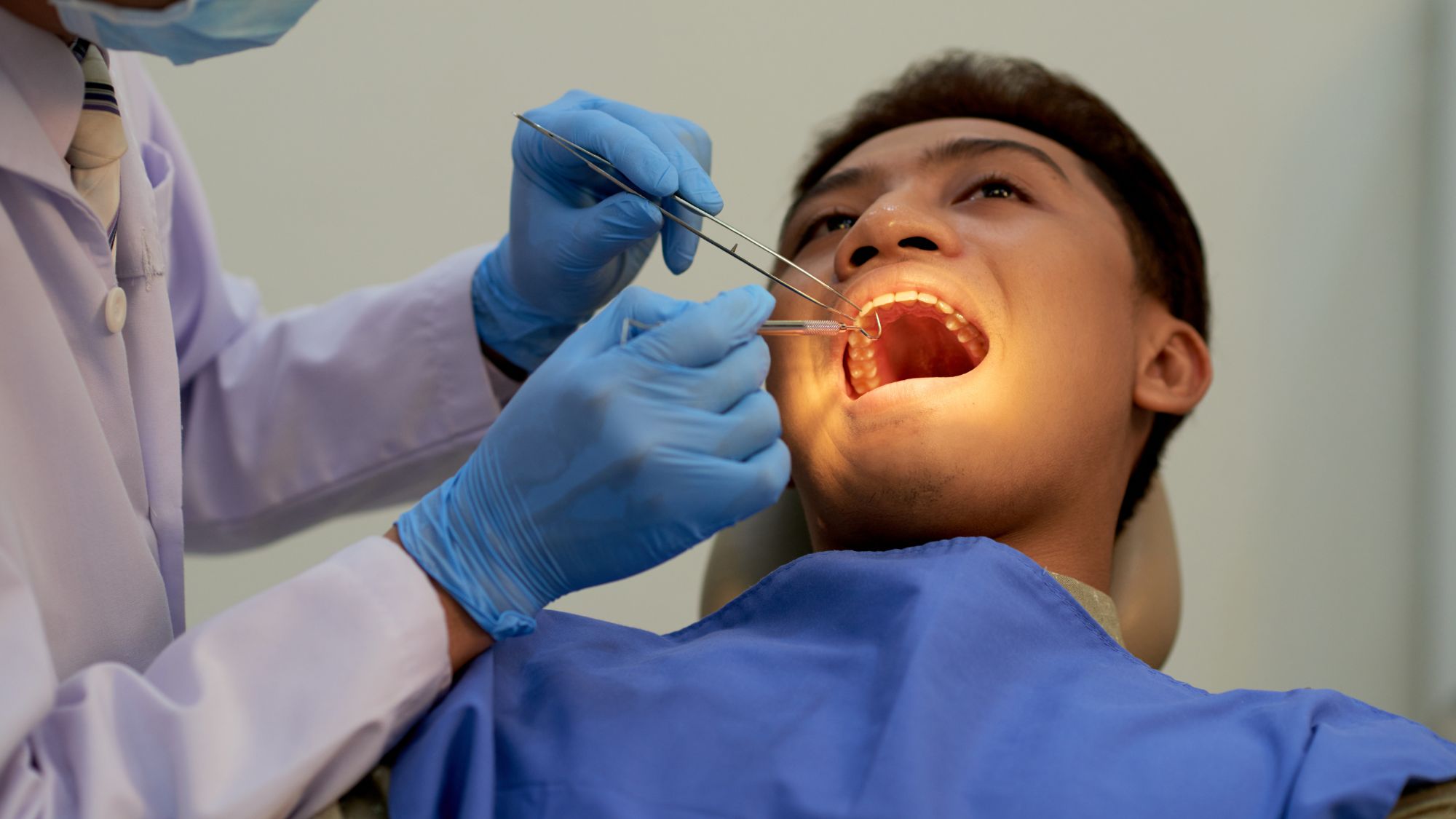 A dentist is undergoing a dental filling process with a patient