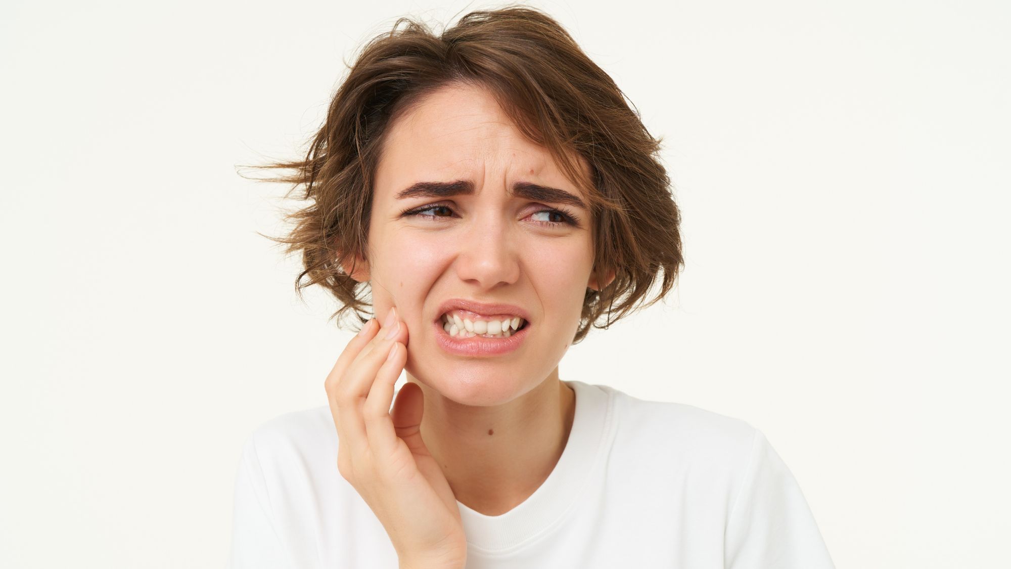 A girl is in pain because she's suffering from a bleeding gums problem